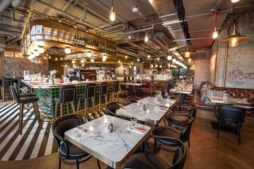 Graffiti-Adorned Industrial Space With a Chic Bar for Trendy Social Events