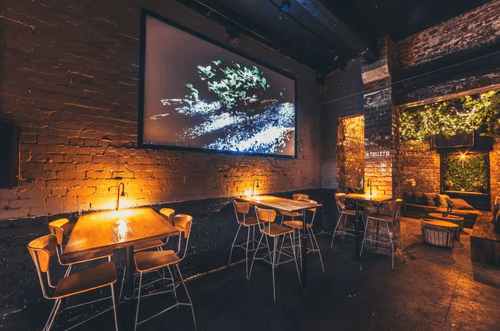 Whimsical Treehouse Bar With Brick Walls and Verdant Greenery for Team Bonding Events