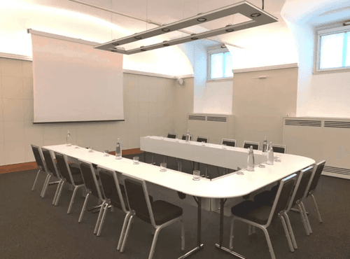 Vaulted Minimalist Room With Soft Uplighting for Leadership Briefings