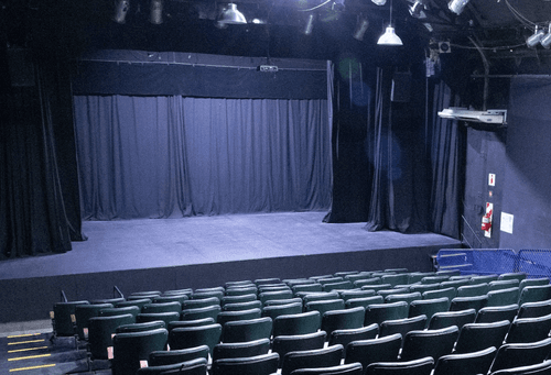 Black-Box Industrial Auditorium With Raked Seating & Pro-Grade Lighting for Conferences and Hackatons