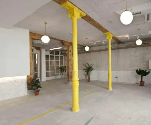 Revitalised Space With Yellow Columns & Raw Aesthetics for Creative Sessions