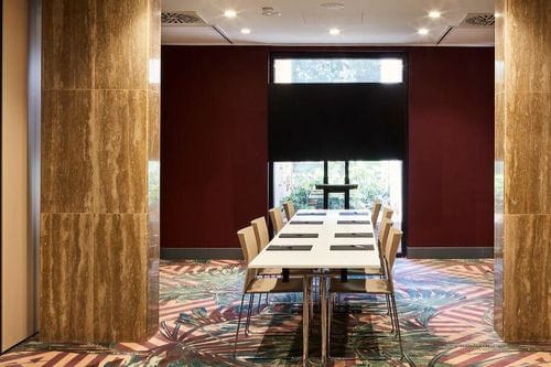 Refined Boardroom With Marble Columns and Rich Hues for High-Level Meetings