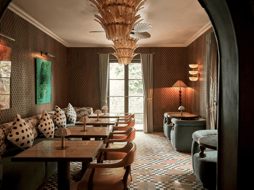 Patterned-Wall Dining Room with Sculpted Chandeliers