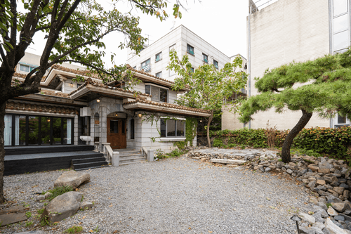 Traditional Stone-Facade Venue With Lush Landscaping for Celebrations and Events