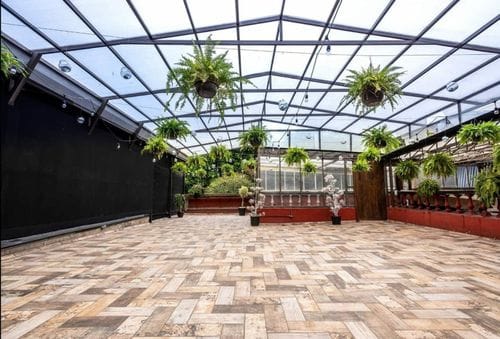 Industrial Indoor Garden Terrace With A Glass Roof for After-Work Cocktail Parties