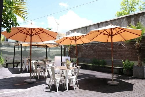 Scenic Patio With Timber Decking and Vibrant Greenery for Engaging Team Sessions