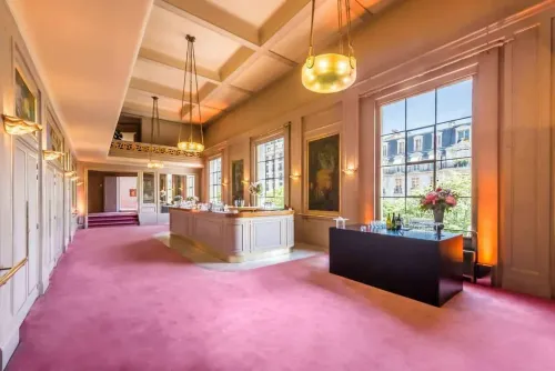 Neoclassical Hall With Plush Pink Carpeting for Chic Social Gatherings