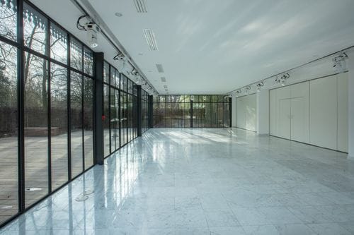 Neoclassical Glass Pavilion With Lush Greenery for Energetic Networking Events