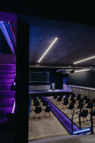 Industrial Minimalist Venue With Sleek Lighting for Dynamic Conferences and Presentations