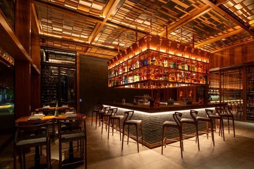 A Luxurious Yet Cosy Setting With a Dramatic Suspended Bar for Gatherings