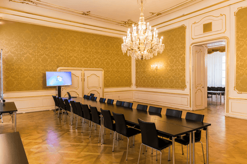Refined Elegance for Corporate Meetings in a Luxurious Golden-Hued Room