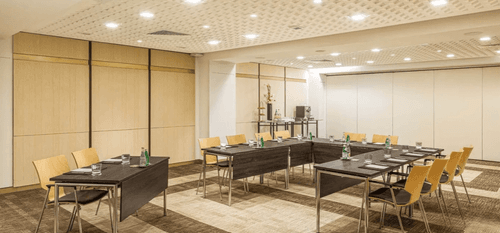 Elegant White Meeting Room With Wooden Panel Decor and Gold Details