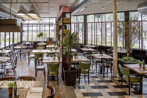 Bright Industrial-Style Setting With Greenery and Flexible Table Arrangements