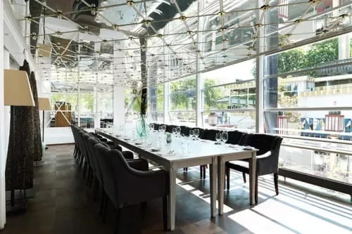Glass Pavilion With Mirrored Ceilings for Relaxed Team Brunches