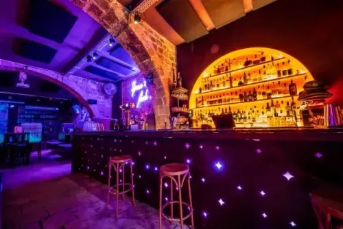 Rustic Stone-Bar Venue With Neon Accents for Corporate Mixers