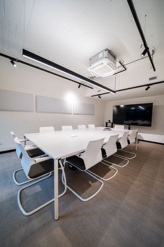 Modern All-White Conference Room With Sleek Outdoor Space for Focused Discussions and Meetings