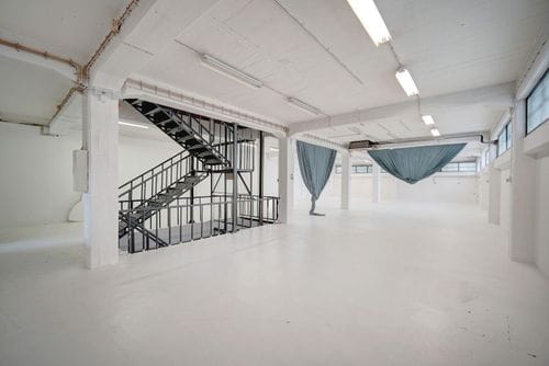 Minimalist White Gallery With Industrial Charm for Artistic Showcases