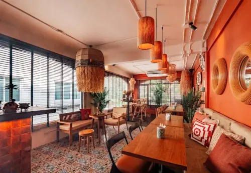 Vibrant Orange Lounge With DJ and Unique Cocktails for Social Events