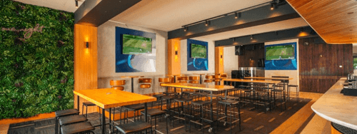 Lush Modern Venue With Bold Greenery Wall for Social and Networking Events