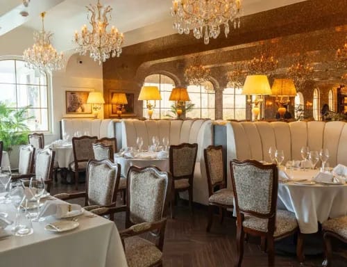 Gold-Accented Dining Room With Chandeliers for Elegant Dinners