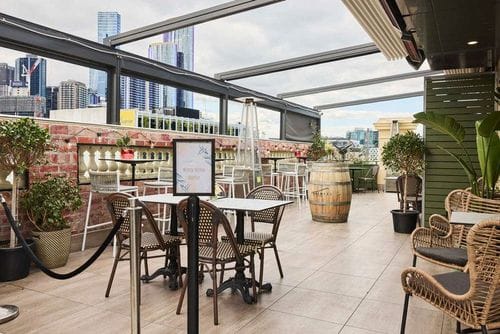 Stylish Open-Air Terrace With Natural Accents and City Views for Casual Networking