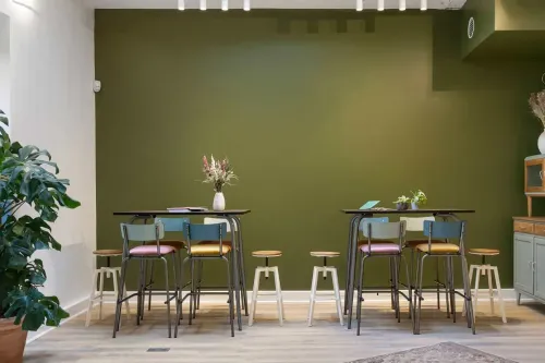 Chic Modern Space With an Olive Green Wall and a Serene Courtyard