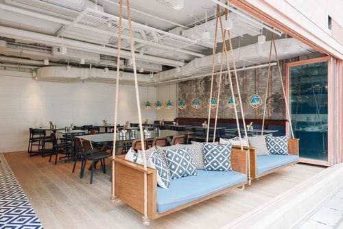 Playful Eatery With Suspended Swing Benches and Open Space for Laid-Back and Unwind Gatherings