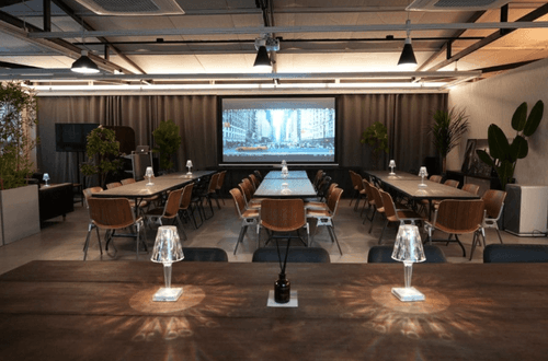 Industrial Conference Hub With Exposed Pipes and Brick Detail for Innovation Workshops