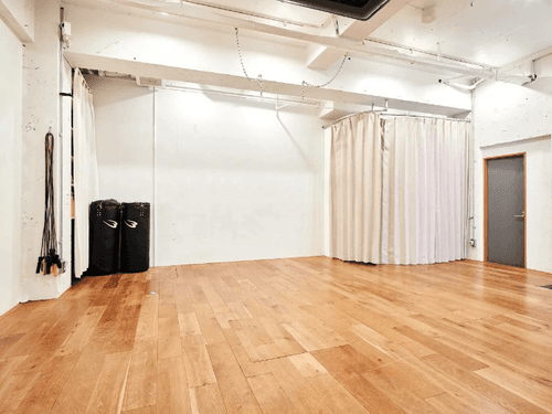 Minimalist White Studio With Sleek Wooden Floors for Fitness Events