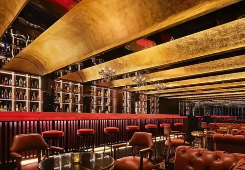 Mood-Lit Cocktail Bar With Gold Ceilings for After-work Celebrations