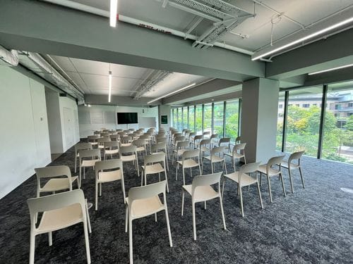 Bright Meeting Room With Exposed Pipes and Outdoor Garden Views for High-Level Discussions