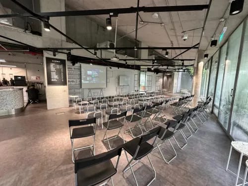 Industrial-Inspired Venue With Floating Frames and Glass Windows for Corporate Talks