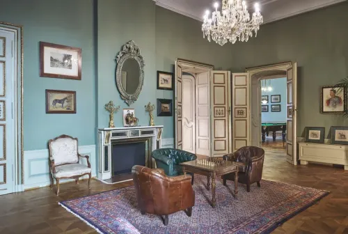 Chandelier-Lit Drawing Room With Leather Seating for Intimate Events