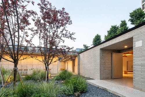 Open-Air Pocket Garden With Concrete Façade for Pre-Event Arrivals