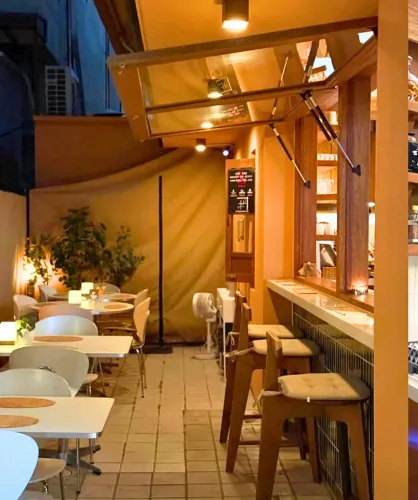 Retractable-Façade Bar With Green Tiles and Bamboo Accents for Networking Dinners