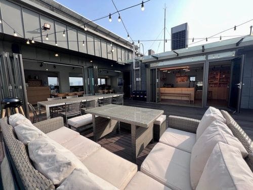 Concrete-Clad Rooftop With Sleek Interior Dining and Chef’s Kitchen for BBQ Evenings