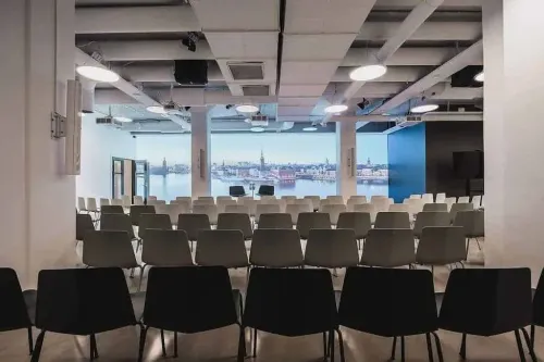 Contemporary Auditorium With Full-Wall Projection for Kick-Off Parties