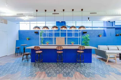 Industrial Chic Venue With Vibrant Blue Accents for Dynamic Conferences
