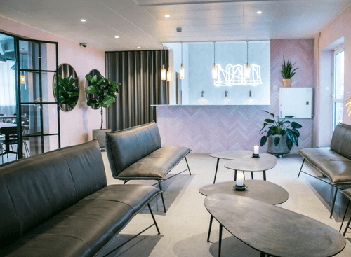 Open-Plan Loft With Neon Reception and Indoor Greenery