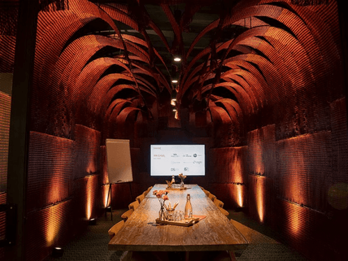 Brick-Walled Boardroom With Sculptural Ceiling for Strategy Meetings