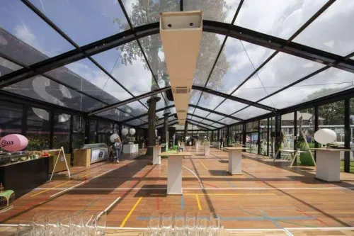 Glass Pavilion With Surrounding Lush Greenery for Garden Parties