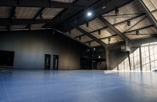 Industrial Chic Hall With a 90-Degree Bar for Dynamic Parties