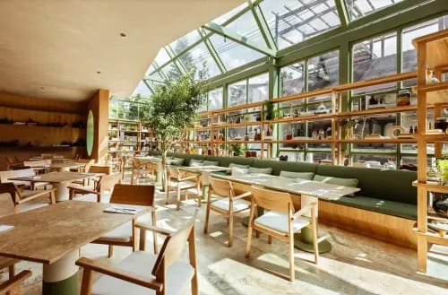 Modern Greenhouse-Inspired Dining Space for Team Celebrations