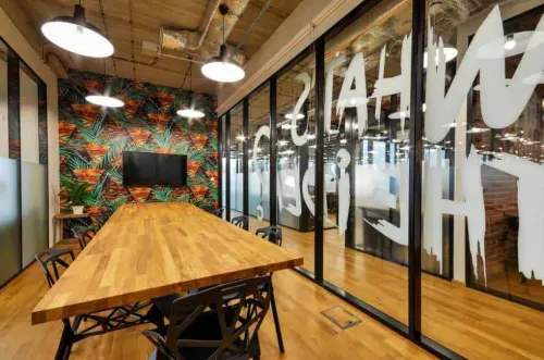 Glass-Walled Creative Boardroom With Tropical Wallpaper for Strategic Sessions