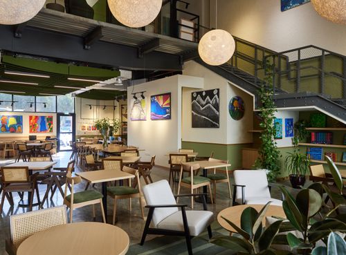 Modern Café With High Ceilings and Vibrant Artwork for Client Lunches and Meetings. Mawaheb Dubai. Cafe