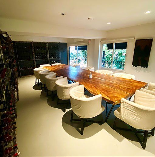Private Dining Room with Wine Display and Wooden Table in Buenos Aires